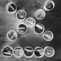 Some ice cream cups arranged in the shape of the 9elements logo on a table.